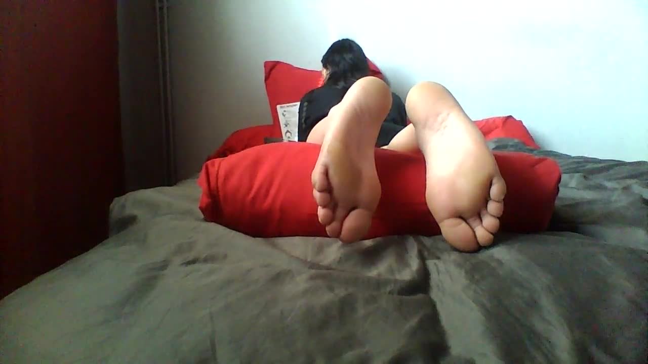 Fantastic brunette laying down in bed exposing her sexy amateur feet and  toes