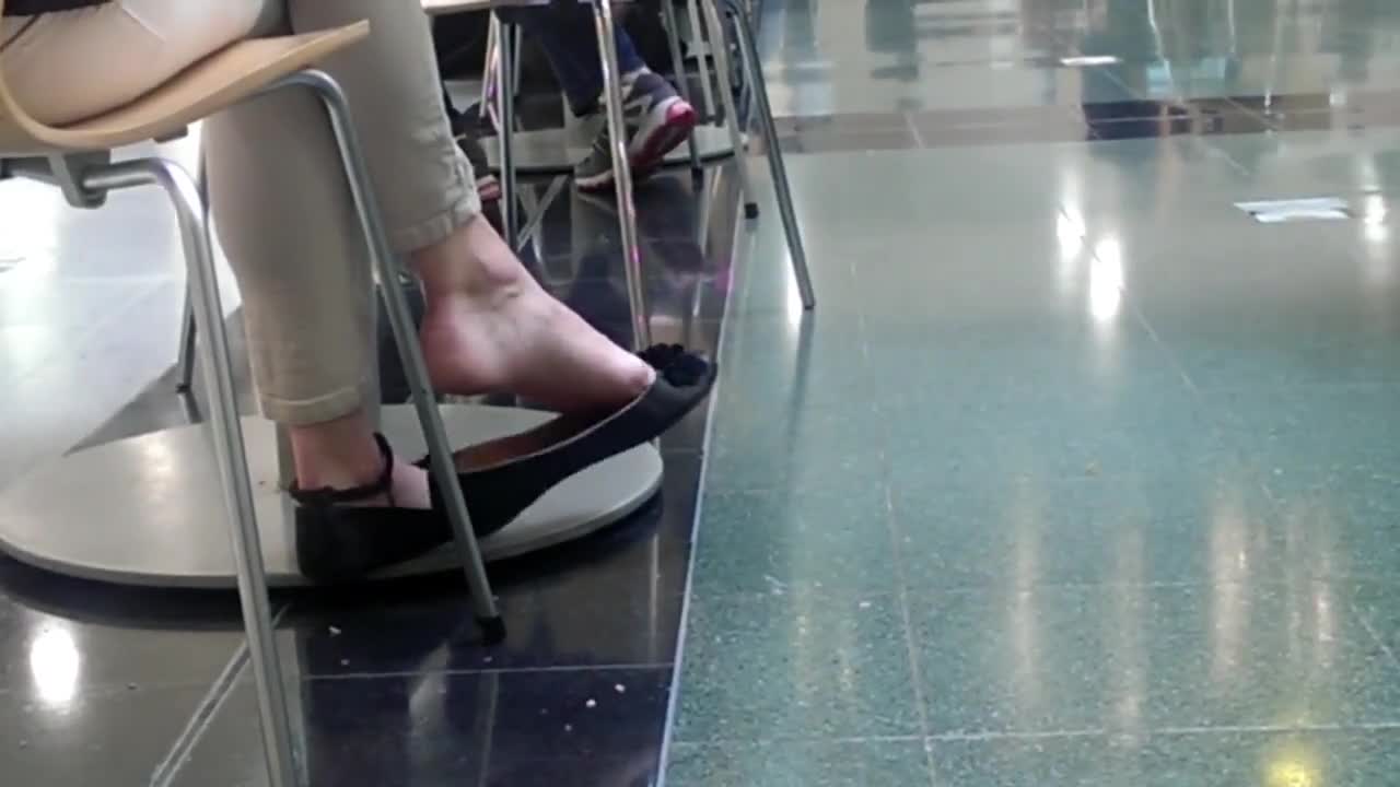 Voyeur filming gorgeous babe dangling her candid feet in public - Feet9