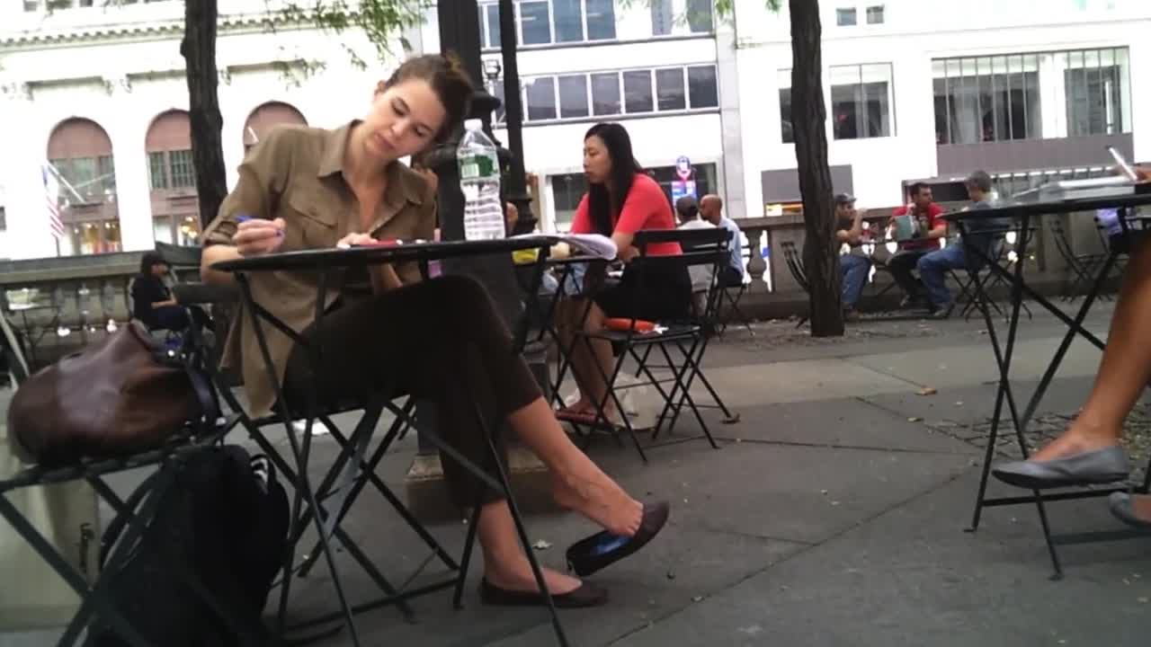 Tall mature woman caught dangling her ballerina shoes in public