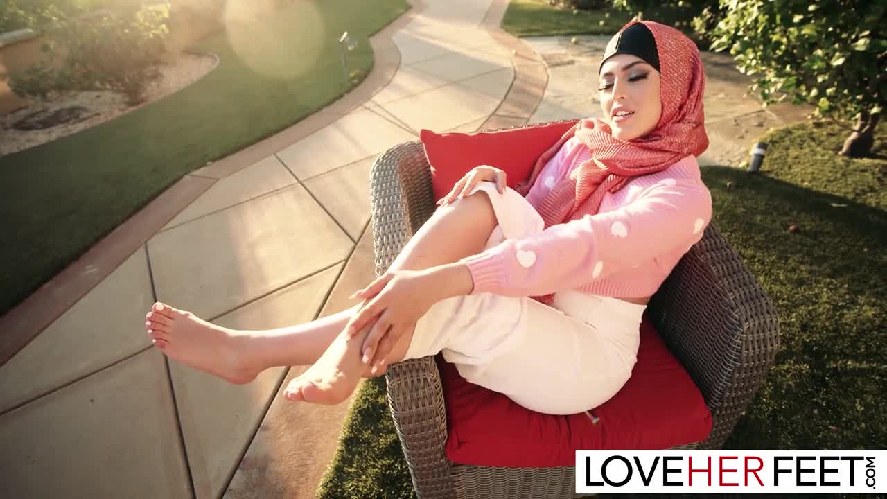 Attractive Muslim lady Sophia Leone unveiling her sensitive feet and toes  outside